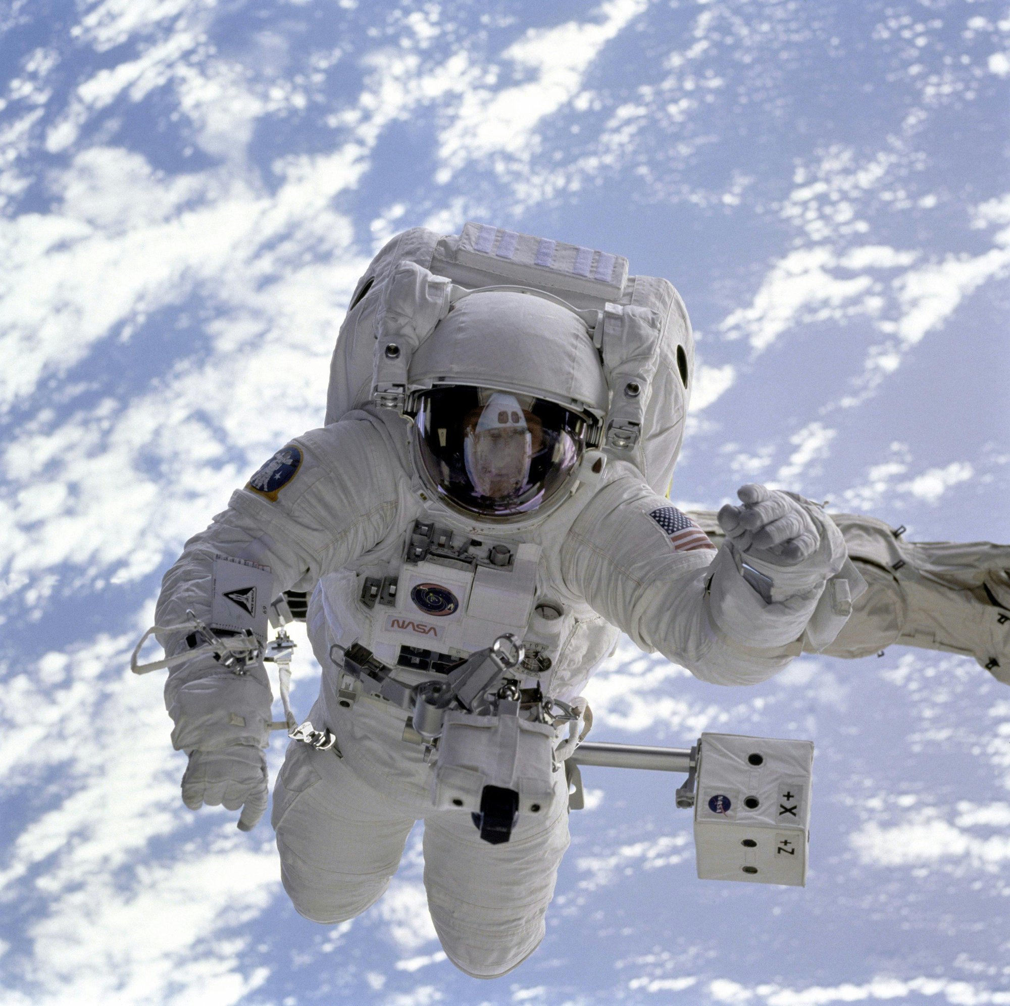 close up of an astronaut wearing spacesuit on a space walk close up of an astronaut wearing spacesuit on a space walk